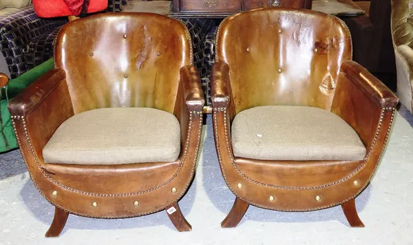 A pair of early 20th century brown leather tub armchairs. (2)