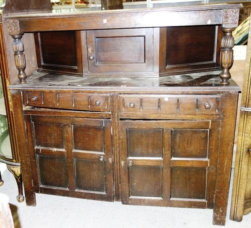 A reproduction oak court cupboard.