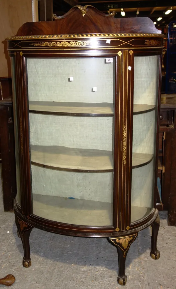 A black and gilt decorated glazed bowfront display cabinet.