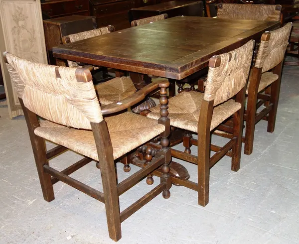 An oak leaf dinning table and a set of six rush seated dining chairs. (7)