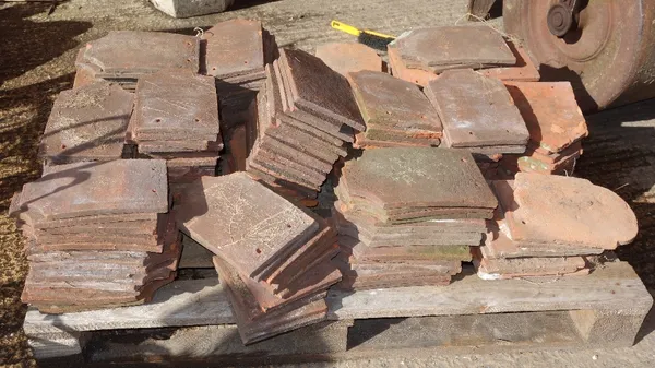 A pallet of approximately 206 various shaped roof tiles.