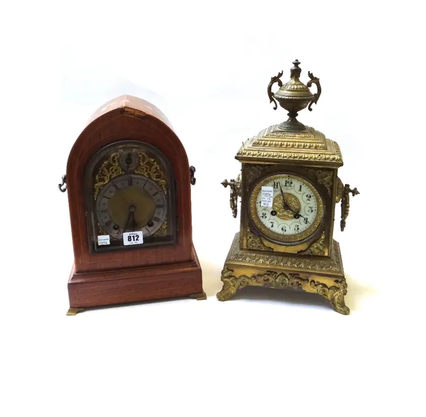 A mahogany cased mantel clock, early 20th century, of navette domed form, with silvered chapter ring and slow/fast subsidiary dial enclosing a two tra