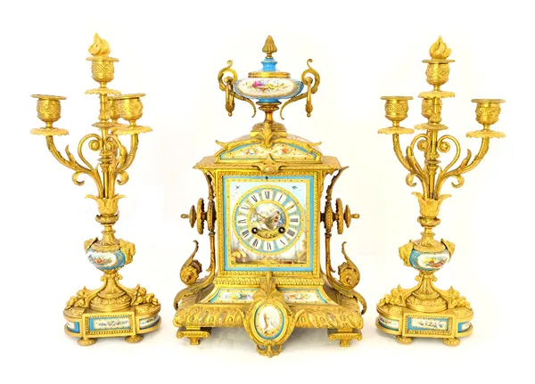 An ormolu and porcelain inset mantel clock garniture, late 19th century, with urn surmount and porcelain dial plate flanked by four branch candelabra