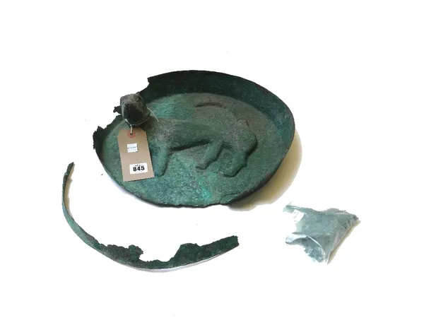 A green patinated bronze roundel relief cast, with a recumbent hound, (a.f), 40cm dia.