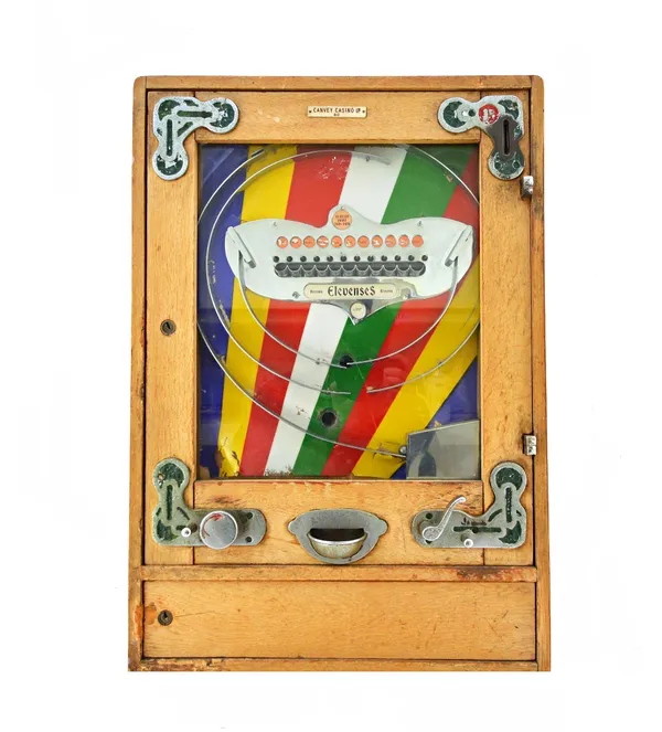A coin operated Bryan's 'Elevenses' amusement machine, English, early 20th century applied plaque 'Canvey Casino' (a.f) 63cm x 44cm x 15cm.  Illustrat