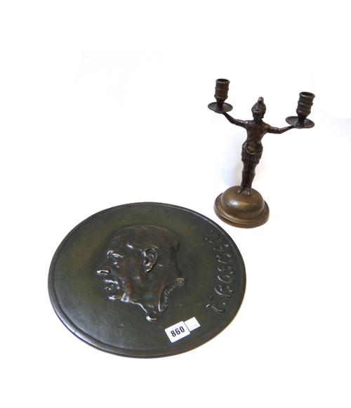 A bronze circular plaque, late 19th century, relief cast with a portrait bust and incised Van Gom pell (34.5cm diameter) and a figural bronze two bran