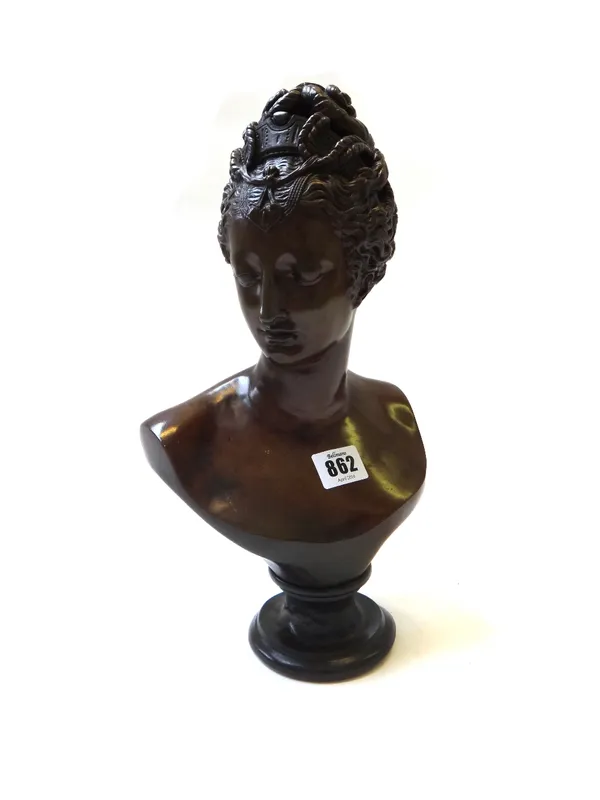 A patinated bronze bust, late 19th century, modelled and cast as a Romanesque female on a socle base, 33cm high.