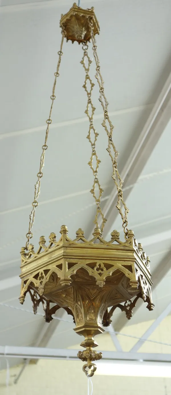 Two similar gilt brass hanging lanterns of Victorian Gothic form, late 19th century, each castellated rim over a tapering spire suspended by linked ch