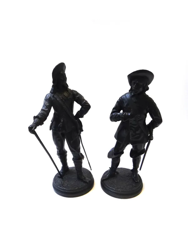 A pair of bronze figures, 19th century, each modelled and cast as a Cavalier in period dress and raised on a circular stepped base, 34cm high (2).