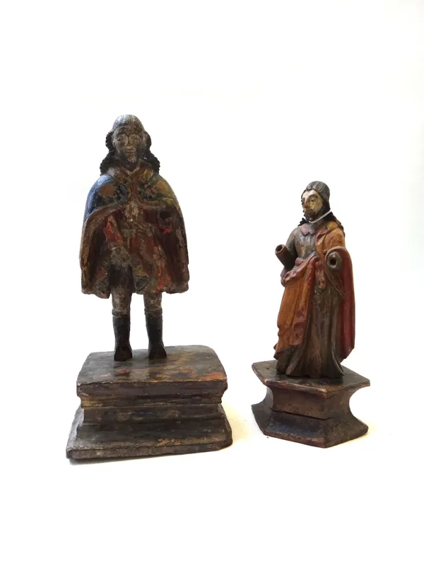 A polychrome painted carved wooden figure, late 17th century, raised on a rectangular plinth, 38cm high, and another polychrome carved wood figure. (2