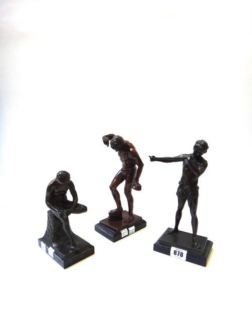 A bronzed spelter figure, early 20th century, modelled and cast as a seated male nude on a marble plinth (16cm high) another as a classical male stand