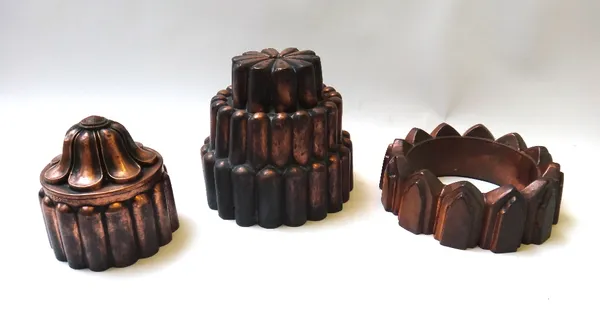 A Victorian copper jelly mould cast as fingers in three graduated tiers, 14cm high, together with another of circular castellated form, 16cm diameter,