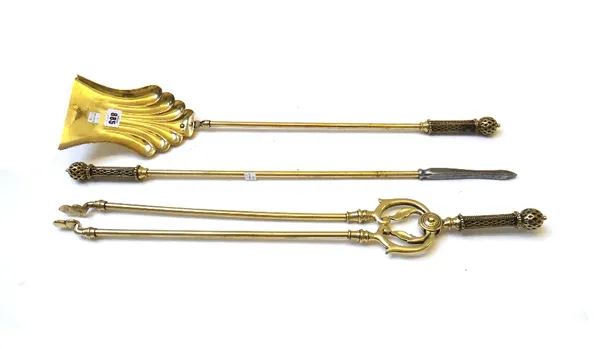 A set of Victorian brass fire irons, with square trellis work handles, the shovel 68.5cm, two wire mesh nursery fenders and a shield shaped fire guard