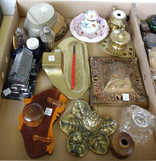 A metal mounted horseshoe inkwell dated 1905, a Victorian brass inkwell, a South East Asian white metal inkwell cast as a church hut on stilts, on a m