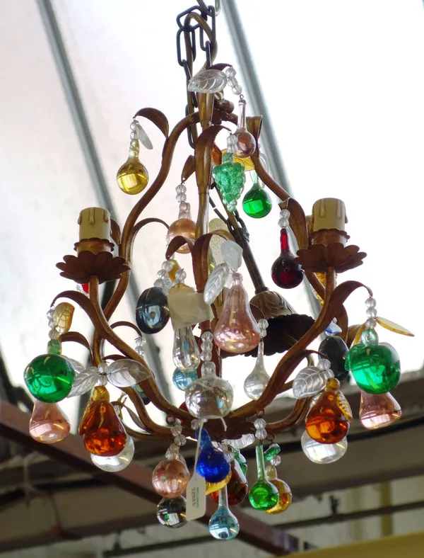 A modern gilt metal three branch chandelier of foliate cast open cage design, hung with coloured glass fruits, 35cm high.