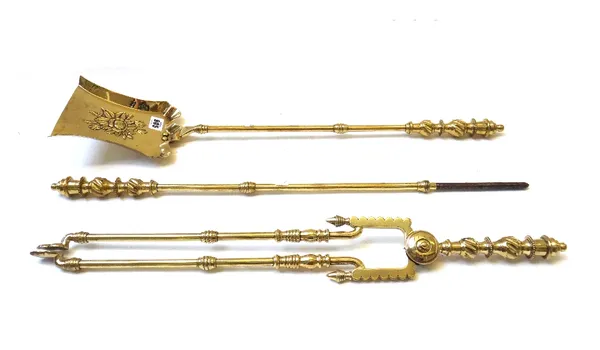 A set of Victorian brass fire irons with wrythen twist handles and knopped shafts, the shovel plate embossed with flowers, 71.5cm (3).