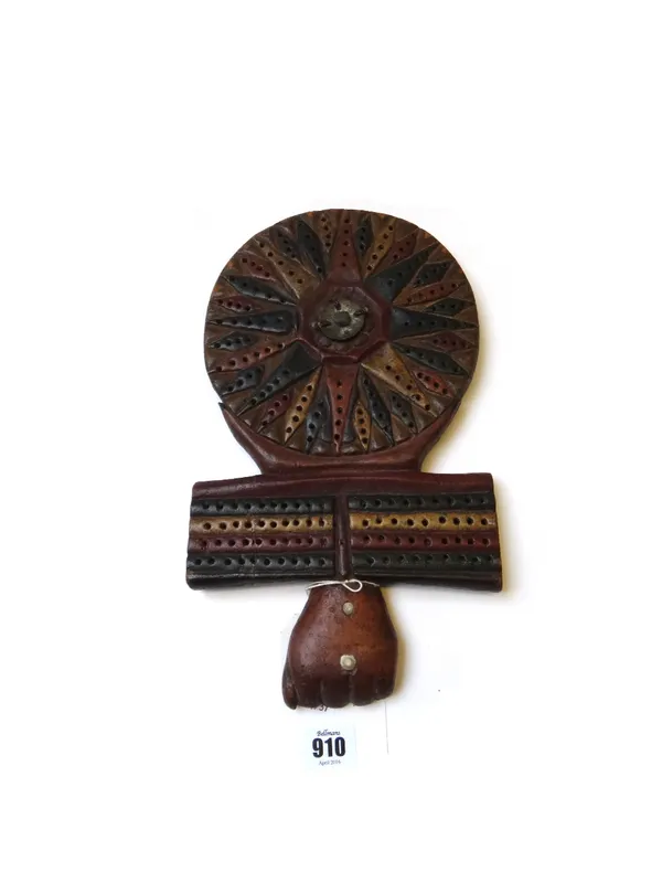 A polychrome carved wooden traverse board, 20th century, with 'fist' surmount over a circular body, (a.f) 33cm high.