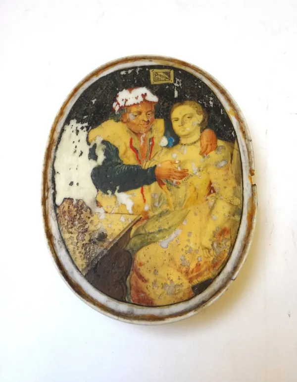 A Queen Anne ivory oval snuff box, early 18th century, the cover painted with an erotic scene and inlaid to the opposite side with brass pique and red