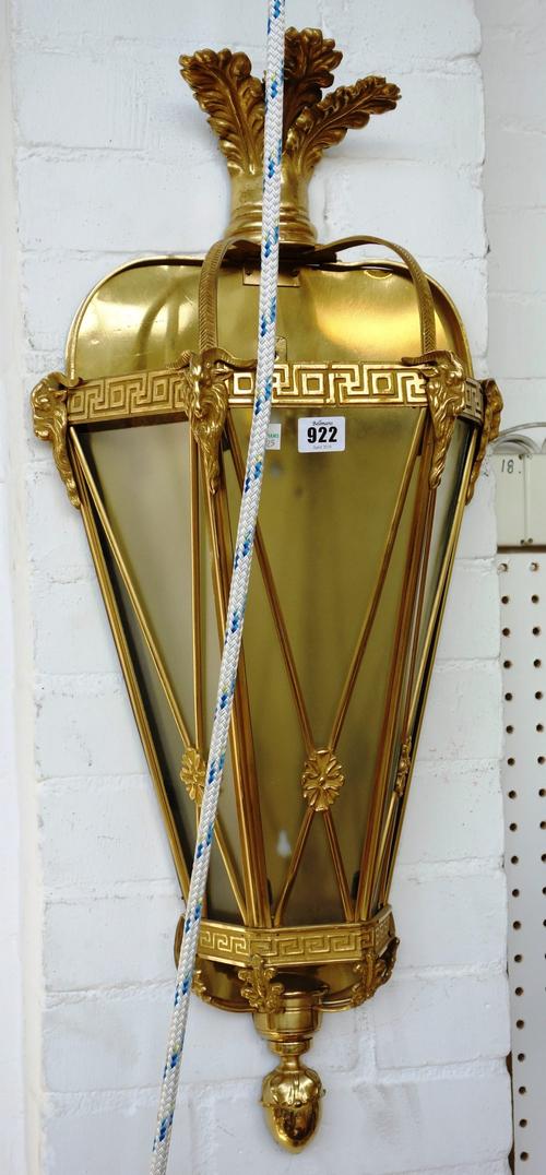 A pair of cast brass wall lanterns, second half 20th century, of Adam style, decorated with rams masks and criss cross strut applied rosettes, 75cm hi