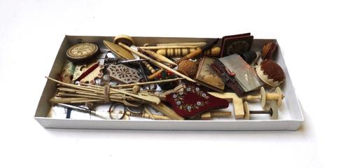 A quantity of 19th century sewing collectables, including; circular ivory carved pin cushions, thread winders, spools, ivory clamps and sundry. (qty)