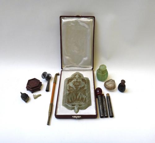 A rock crystal type hardstone pipe bowl, with foliate carved decoration, 5cm long, together with a white metal and hardstone mounted opium pipe, a gre