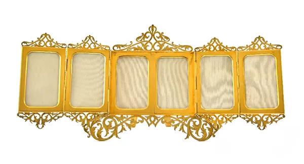 A French brass fold out photograph frame by A. Lavenir, Paris, 1883, the six apertures with foliate scroll borders, on a strut back stand, 40cm wide.