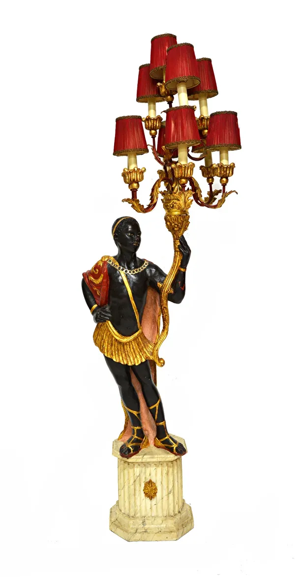 A modern polychrome painted carved wooden ten branch figural candelabra, modelled as a blackamoor figure atop a fluted marbled column, 168cm high over