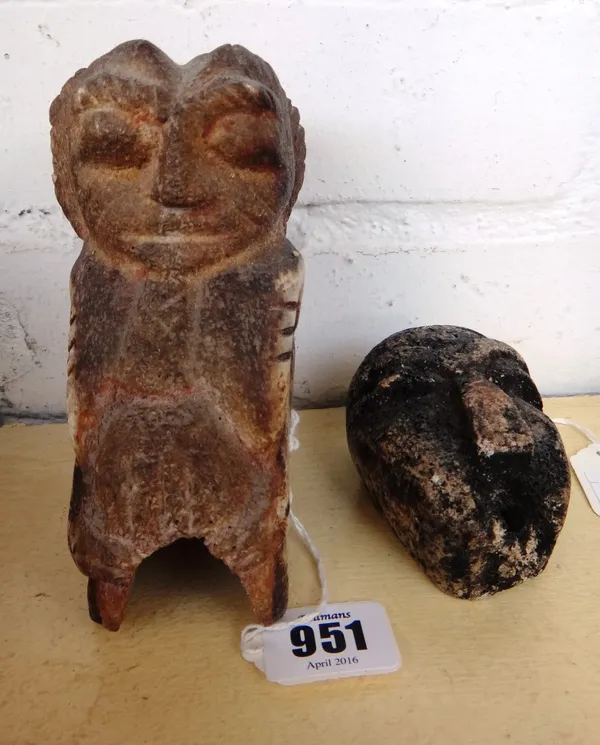 An African tribal bone figural carving, 14cm high, together with a small 19th century bone mask, 8cm high, and three reptile skins. (5)