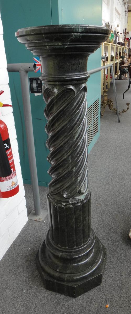 An Italian green vein marble column/jardiniere stand, 20th century, the shaft of spiral twist and lobed sectional form, on an octagonal foot, 112cm hi