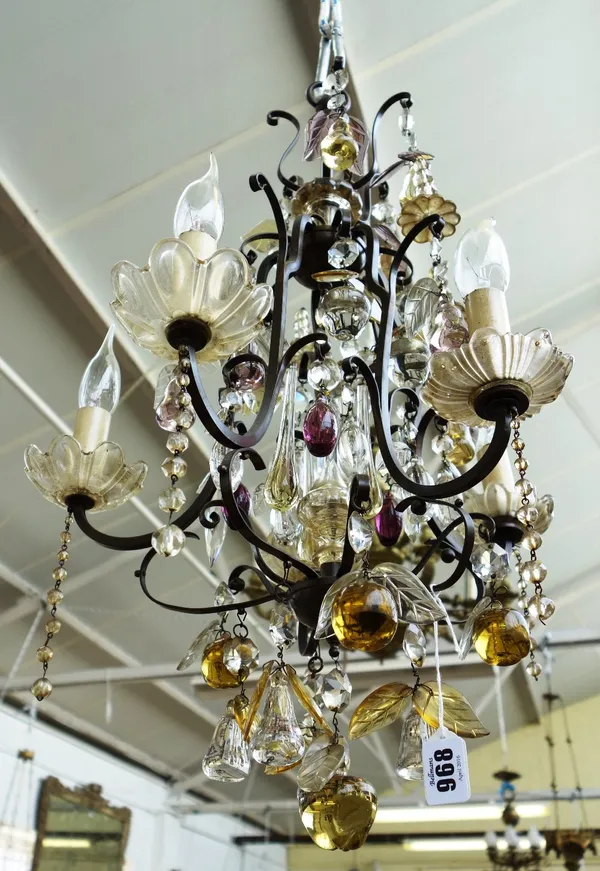 A modern five branch metal and glass chandelier hung with coloured glass fruits over three graduated tiers, 54cm high.