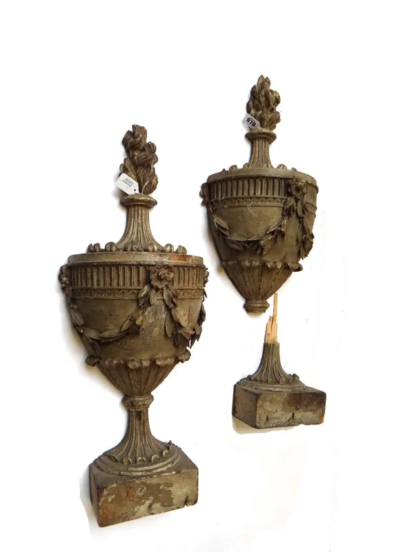 A pair of carved wooden wall appliques, late 19th century, with later additions, each grey painted and carved as a flaming urn decorated with foliate