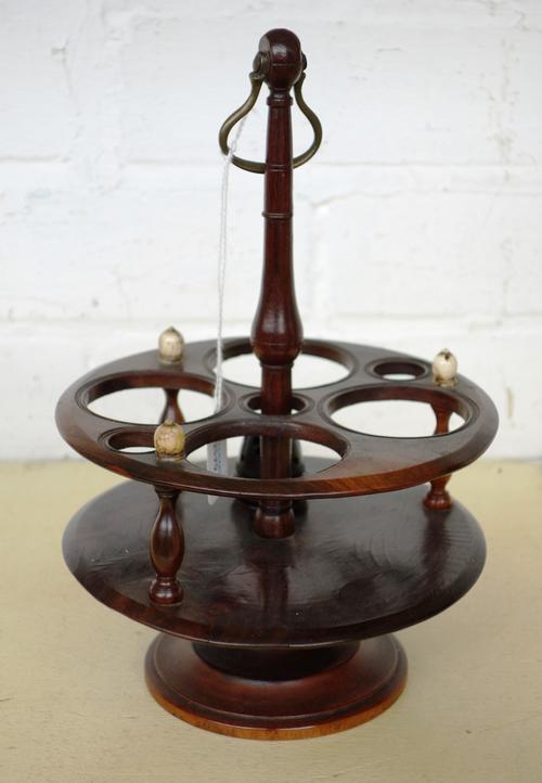A Georgian style hardwood and ivory mounted ormolu condiment stand, with central handle and six circular condiment reservoirs, on a circular foot, 24c