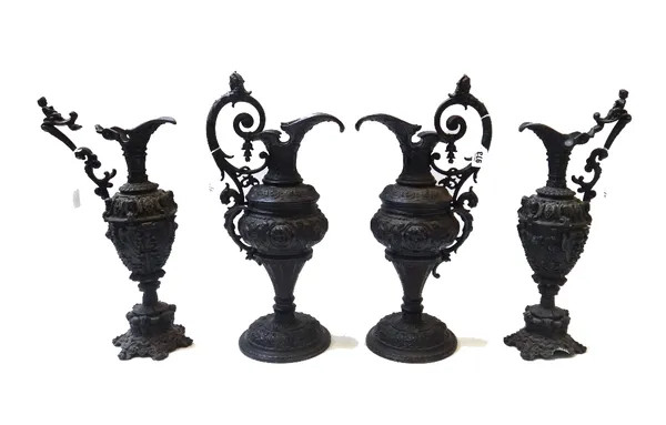 A pair of black painted spelter ewers of classical form, early 20th century, 46cm high, and a similar pair of smaller ewers (a.f). (4)