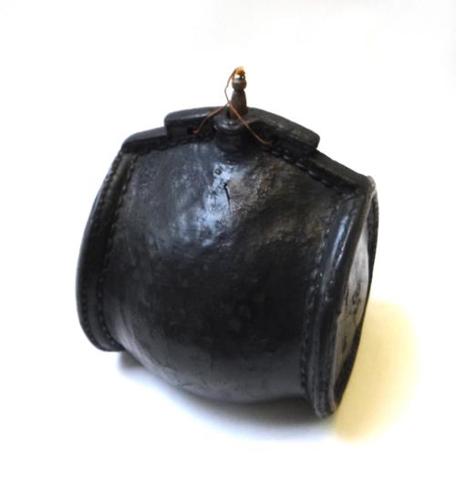 An English tooled leather Blackjack bottle, 17th century, decorated with punched star and 'FARRINGTON' to the base, 17.5cm wide.