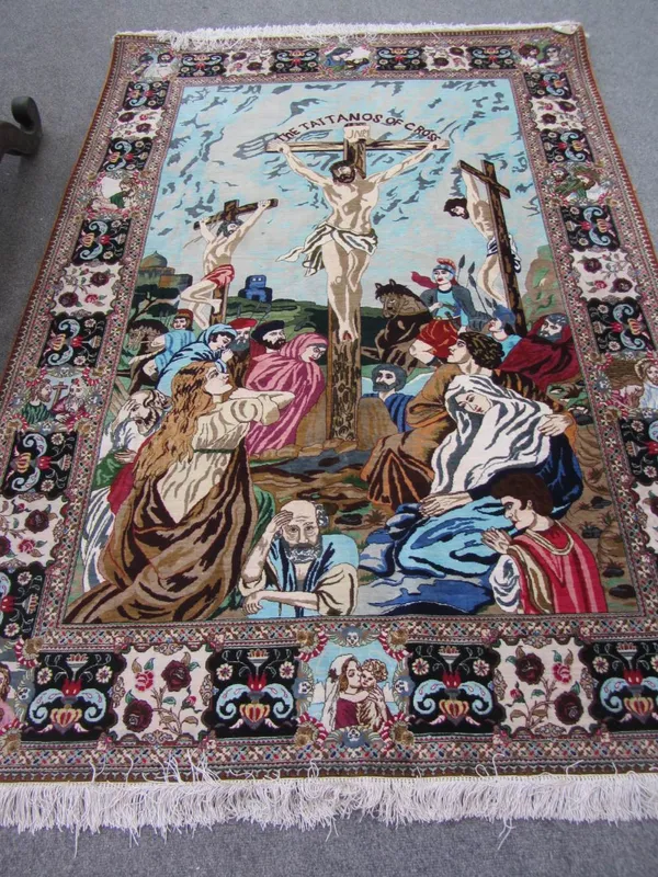 A Ghom silk pictorial rug, Persian, of The Taitanos Cross, the landscape with three crosses and Agures, the cartouche borders with depictions of the l