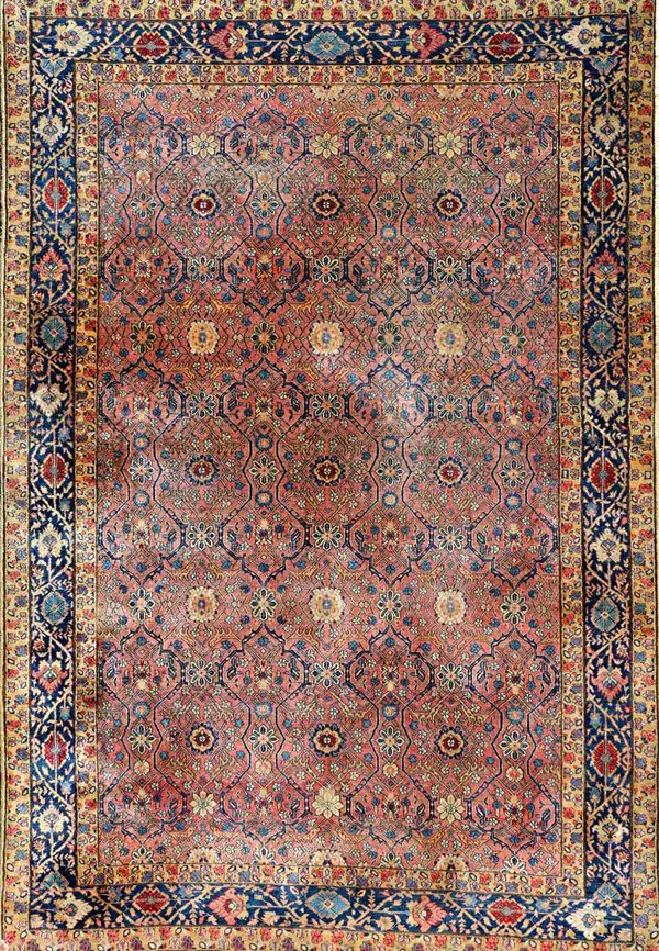 A Khorrasan rug, the pink field with a delicate trellis design with single flowerheads, an indigo flower and vine border, 224cm x 155cm.   Illustrated