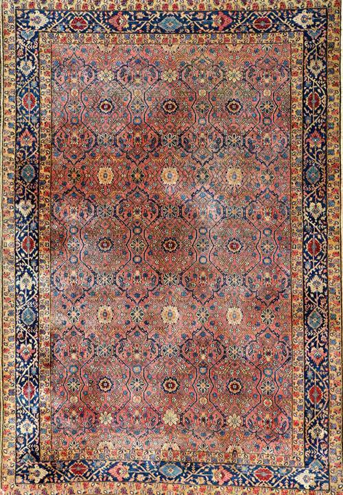 A Khorrasan rug, the pink field with a delicate trellis design with single flowerheads, an indigo flower and vine border, 224cm x 155cm.   Illustrated