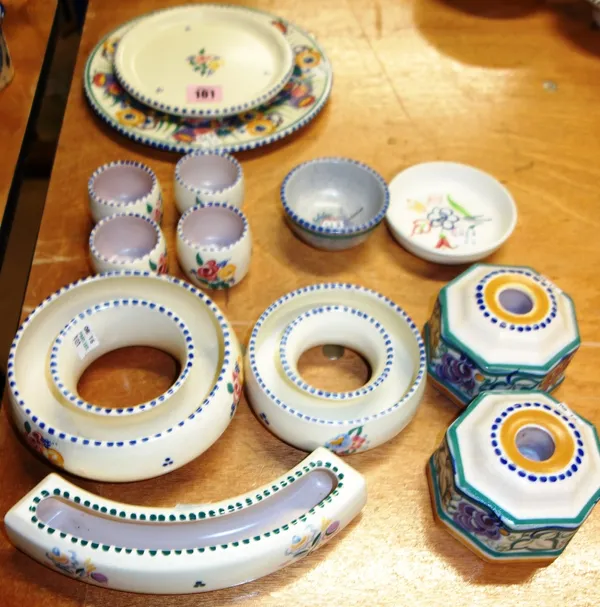 A quantity of Poole pottery to include;  three flower holders, pair candlesticks, 4 egg cups, 2 plates and 2 other items. (qty)