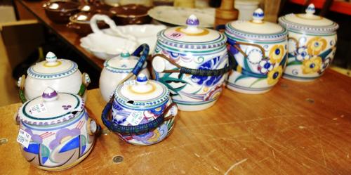 A quantity of Poole pottery lidded barrels with woven basket handles to include;  3 biscuit barrels and 4 jam pots (7)