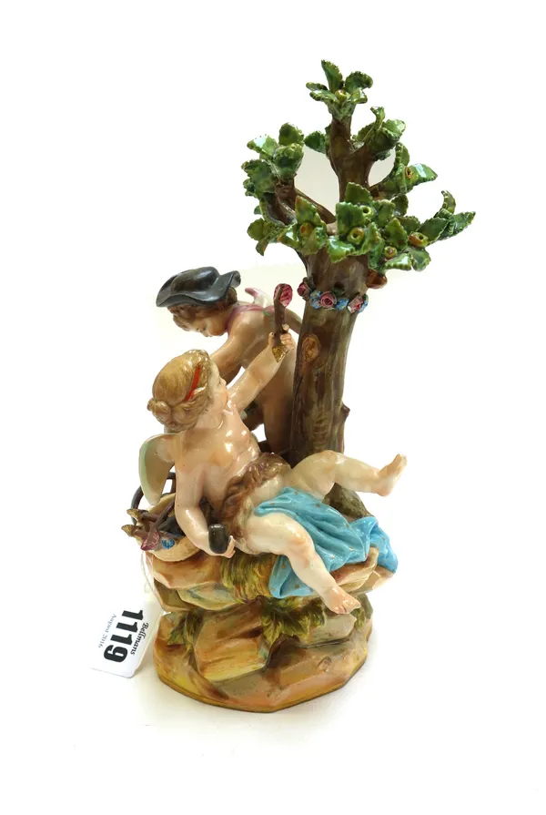 A Meissen figure group, late 19th century, modelled with Cupid sharpening his arrows on a wheel, the reverse with a scantily draped putto holding an a