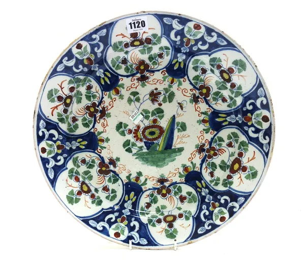 An English delftware polychrome charger, probably Bristol, circa 1760, foliate decorated and with painted blue mark to rear, 35.7cm diameter.
