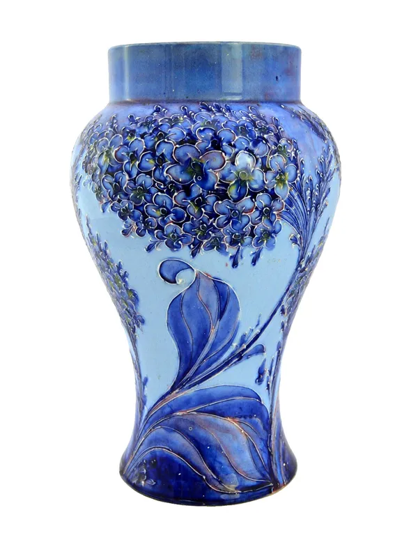 A Moorcroft Florian ware vase, circa 1902, decorated in the 'Lilac' pattern in tones of blues against a baluster ground, brown printed marks and a gre