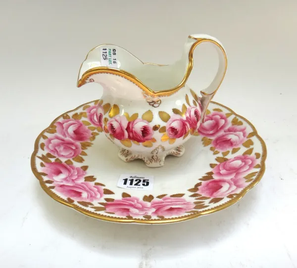 A Victorian matched part tea service decorated with roses against a gilt white ground, comprising; a milk jug, a sugar bowl, two serving plates (21.5c