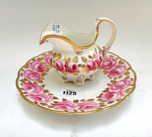 A Victorian matched part tea service decorated with roses against a gilt white ground, comprising; a milk jug, a sugar bowl, two serving plates (21.5c