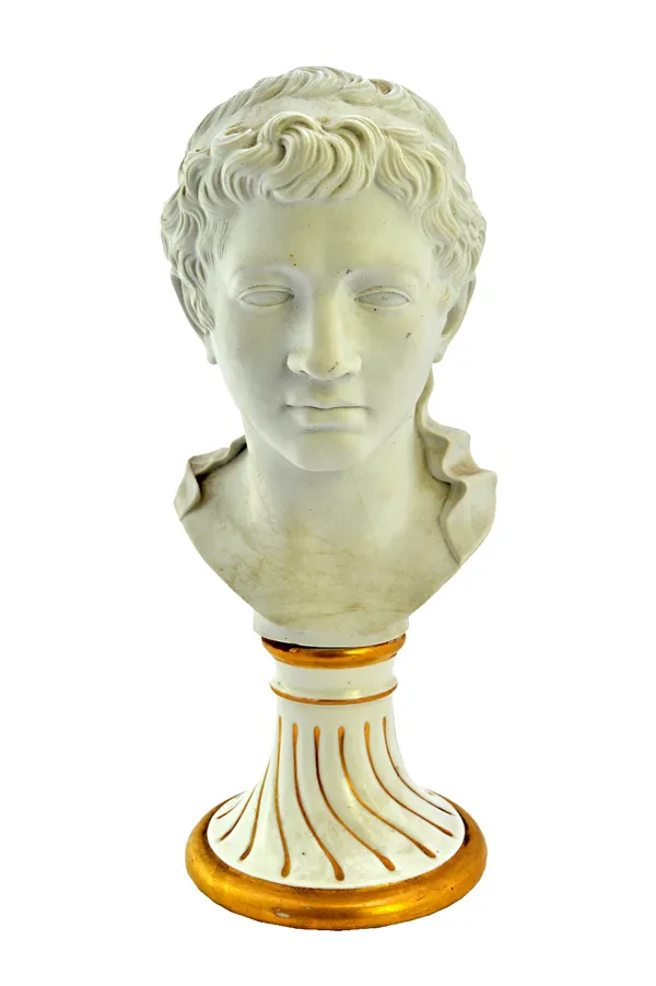 A Furstenberg biscuit bust of Ptolemaeus, 1770's, probably modelled by Desoches, raised on a glazed white and gilt spiral gadrooned base, incised 'PTO
