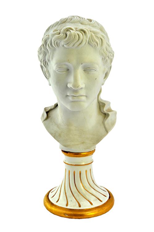 A Furstenberg biscuit bust of Ptolemaeus, 1770's, probably modelled by Desoches, raised on a glazed white and gilt spiral gadrooned base, incised 'PTO
