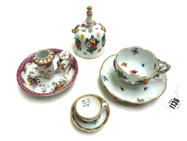A Meissen floral encrusted tea cup and saucer, 20th century, together with a similarly decorated Meissen porcelain hand bell, a Meissen outside decora