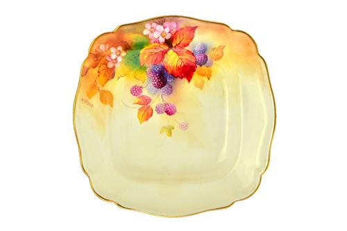 A Royal Worcester porcelain dessert service for Maple, circa 1933, painted with fruit against a blush ivory ground, signed 'K. Blake', comprising; twe