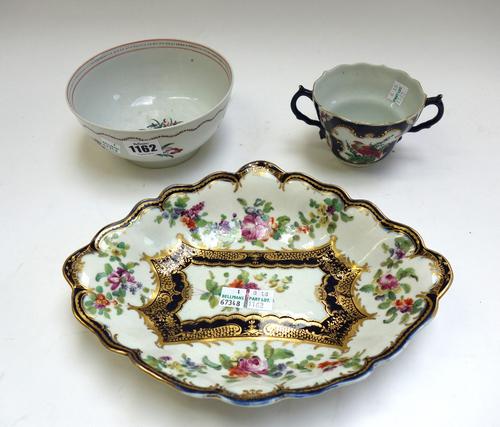 A Worcester blue-scale ground chocolate cup, circa 1770, painted with gilt framed panels enclosing birds, flowers and insects, with blue fretted squar