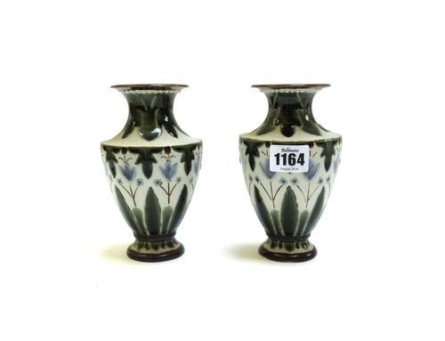 A pair of Fulham Pottery stoneware vases, late 19th century, incised with flowers and leaves and glazed in lilac, green and cream, incised Fulham, 15c